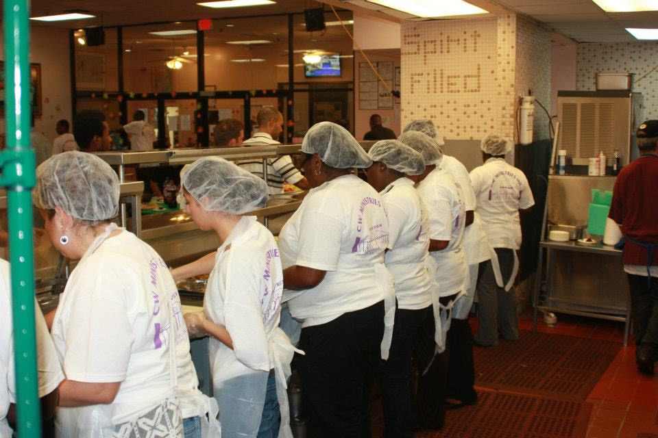 C.W. Ministries volunteers serving meals at community feeding event